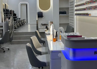 Modern interior of Palette Nails Studio in New York, New York, US with sleek nail stations and vibrant polish display.
