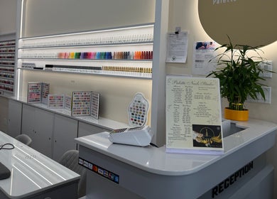 Reception area at Palette Nails Studio, New York, NY featuring stylish decor and nail polish displays.