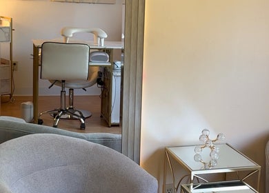 Modern nail salon interior at Eva Nails, Sonora, California, US, highlighting stylish seating and decor.