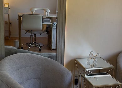 Elegant interior of Eva Nails salon in Sonora, California, showcasing modern seating and styling area.