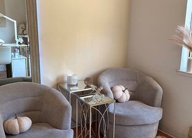 Elegant waiting area at Eva Nails in Sonora, California, US. Features chic chairs and decor.