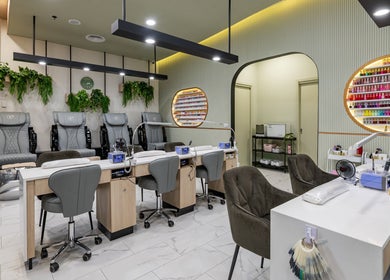 Beauty Genesis - Brunswick in Melbourne, Victoria with stylish nail salon seating and vibrant polish display.