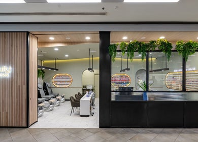 Modern nail salon interior at Beauty Genesis - Brunswick, Melbourne, Victoria, AU, featuring sleek design and greenery.