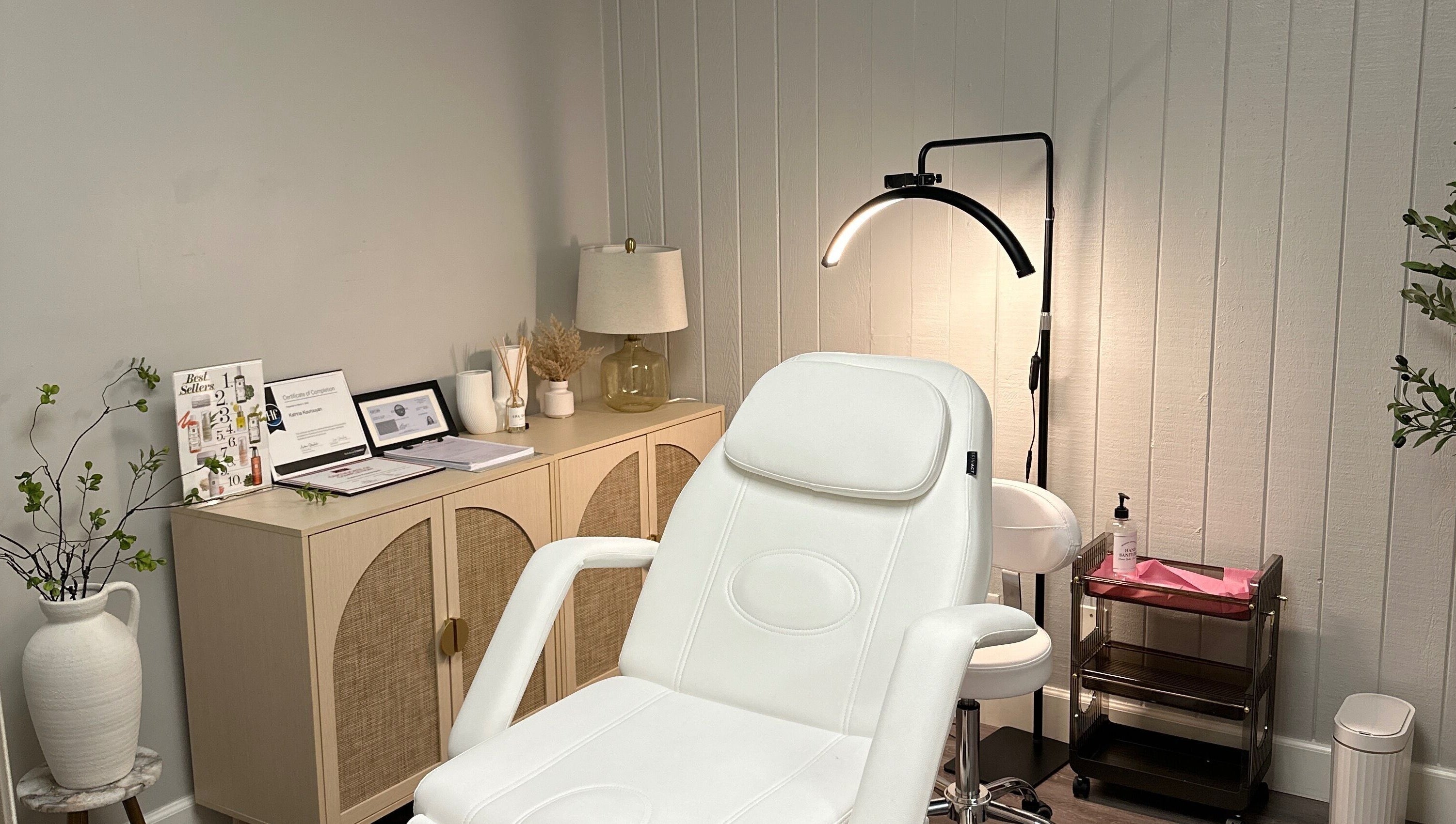 Cozy beauty treatment room at All Things Skyn, Glendale, California, US featuring a modern white chair.