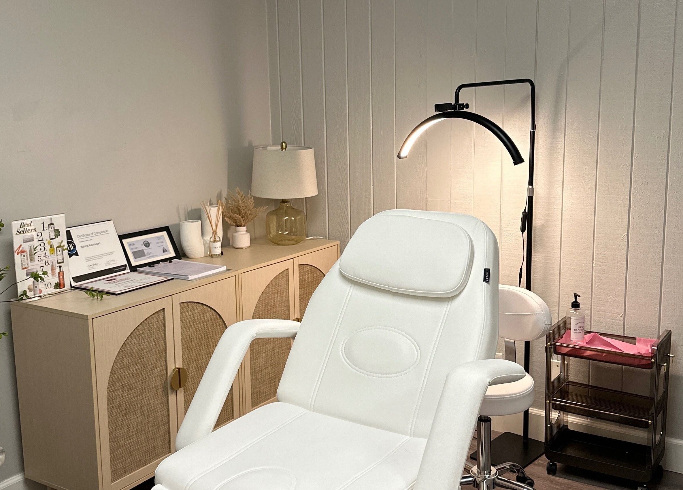 Cozy beauty treatment room at All Things Skyn, Glendale, California, US featuring a modern white chair.