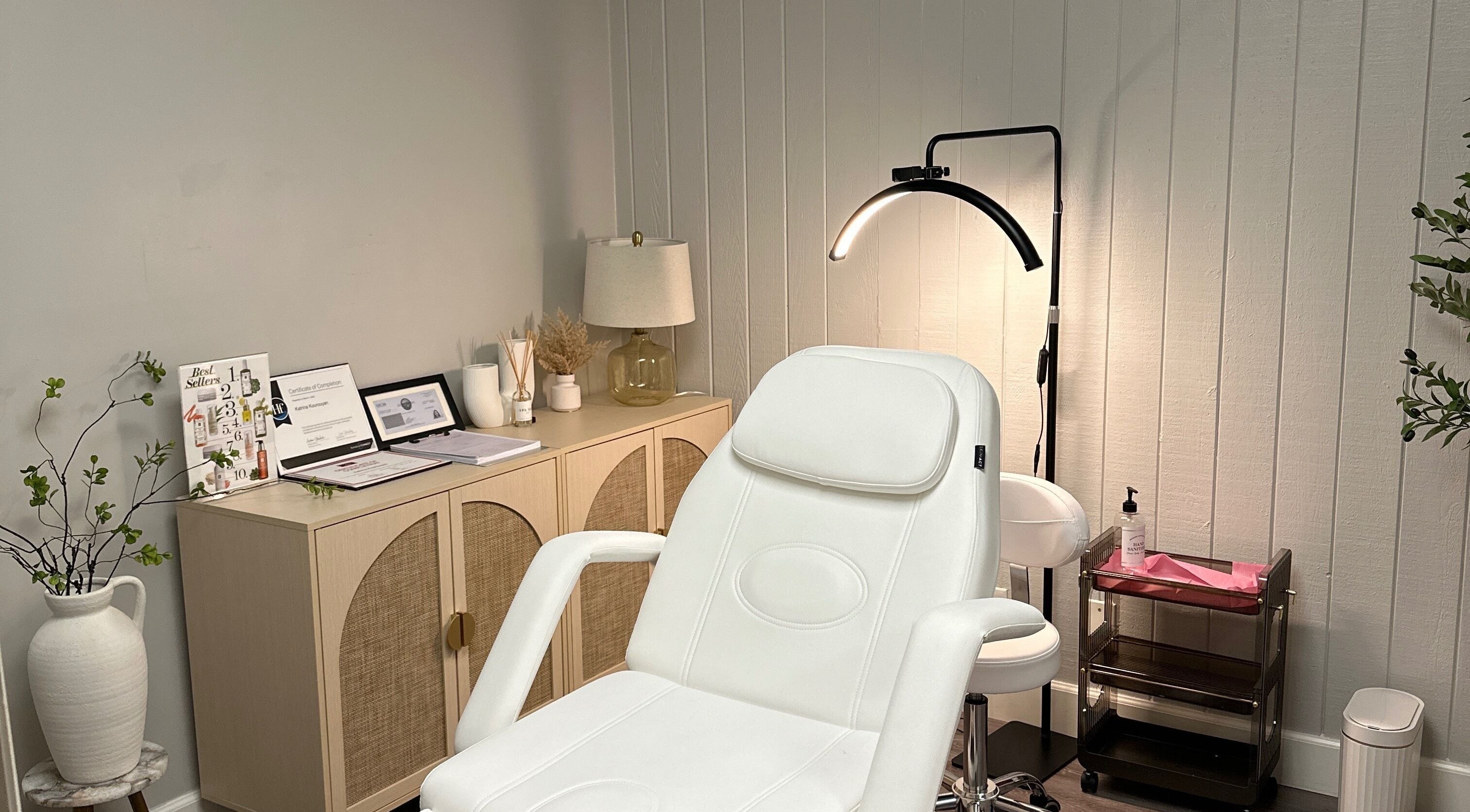 Cozy beauty treatment room at All Things Skyn, Glendale, California, US featuring a modern white chair.
