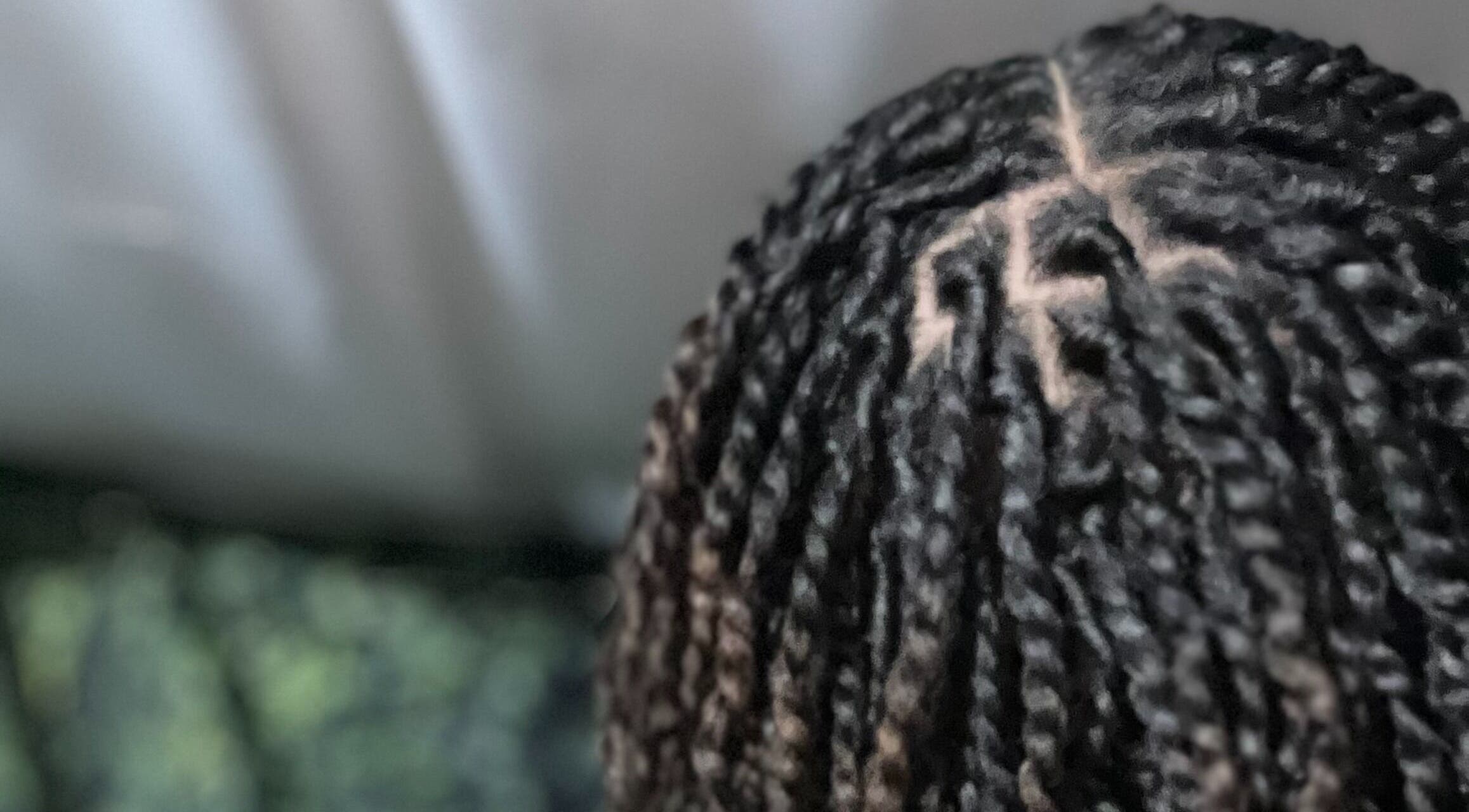 Detailed view of braided locs at Loc'd In Love, Perris, California, US showcasing intricate hair artistry.