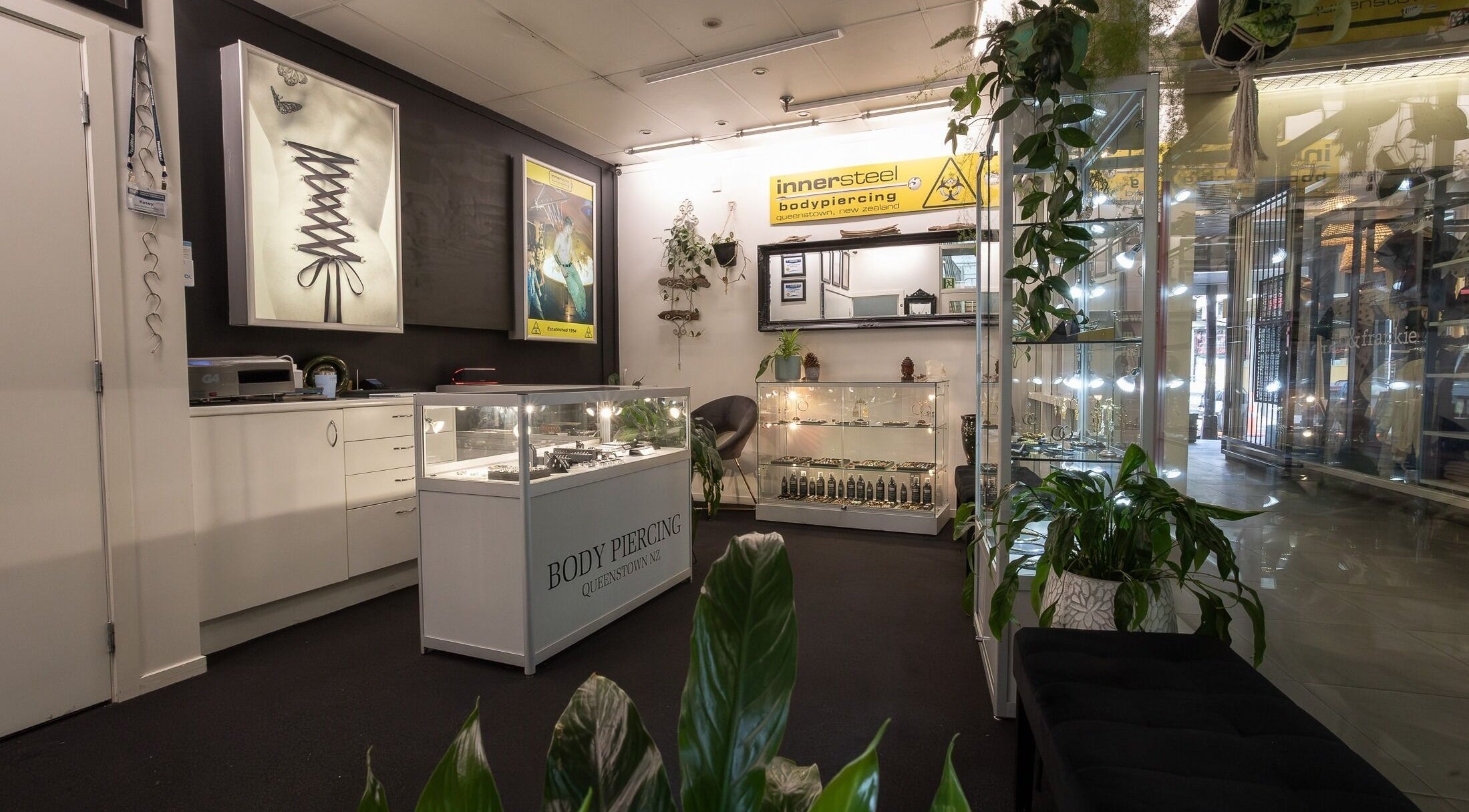 Interior view of Innersteel Body Piercing in Queenstown, Otago Region, NZ, showcasing display cases and decor.
