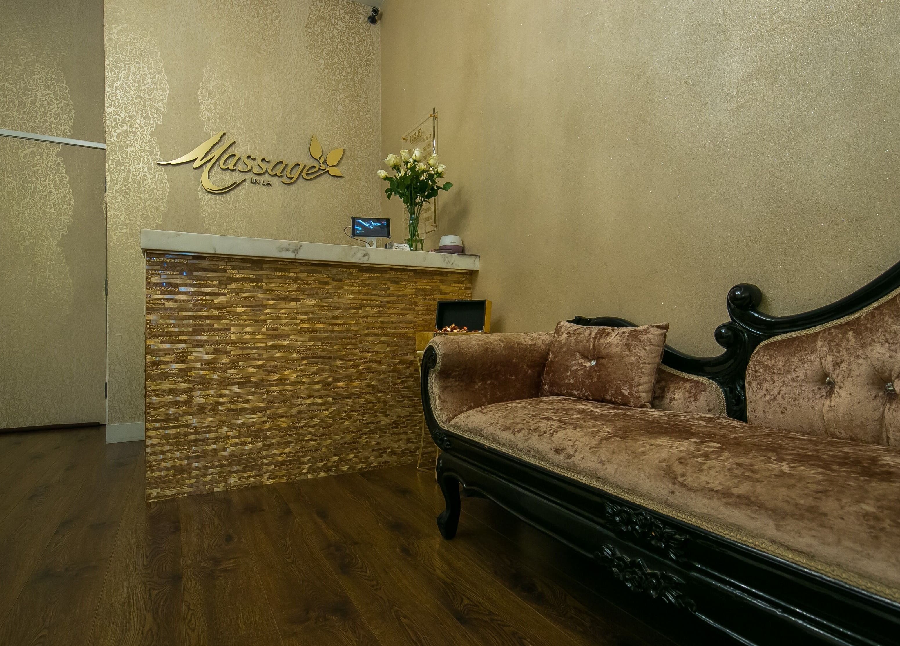 Luxurious spa reception at Massage In LA, Los Angeles, California, US, featuring a plush velvet loveseat.