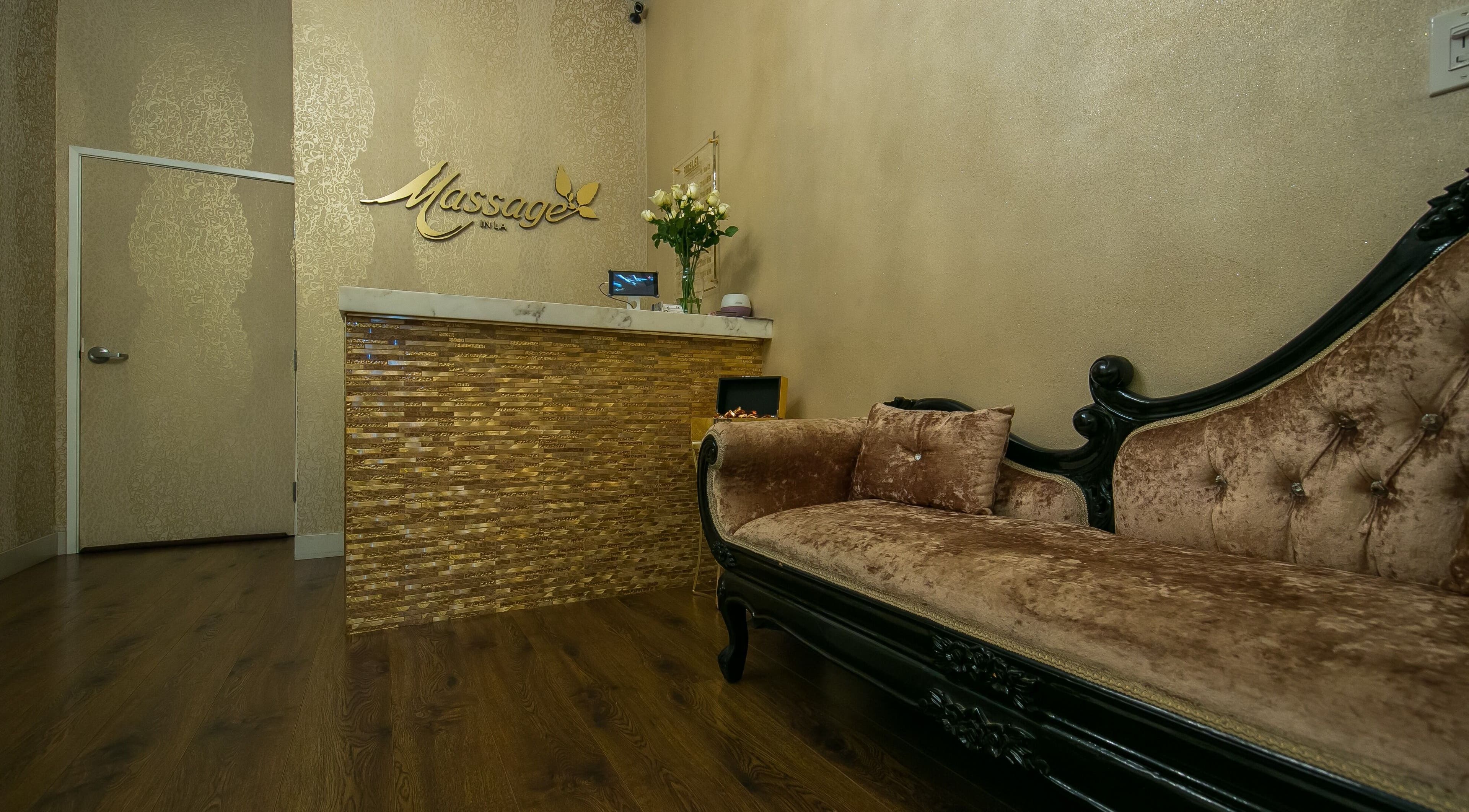 Luxurious spa reception at Massage In LA, Los Angeles, California, US, featuring a plush velvet loveseat.
