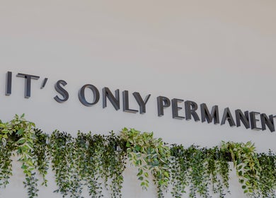 Wall decor with 'It's Only Permanent' at Colibri Tattoo and Piercing Ottawa, Ottawa, Ontario, CA.