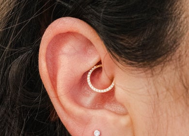 Delicate gold hoop piercing at Colibri Tattoo and Piercing Ottawa, Ottawa, Ontario, CA.