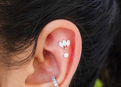Stylish ear piercing at Colibri Tattoo and Piercing Ottawa, Ontario, CA, showcasing elegant jewelry.