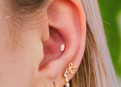 Stylish ear piercing with gemstone at Colibri Tattoo and Piercing Ottawa, Ottawa, Ontario, CA.