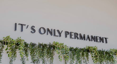 Interior design with 'It's Only Permanent' sign and plants at Colibri Tattoo and Piercing Ottawa, Ontario, CA.