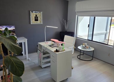 Modern nail salon interior at The Nail Edit, Butler, Western Australia, AU, featuring sleek furniture and natural light.