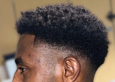 Modern curly fade hairstyle at London Made Paris, London, England, GB, showcasing exquisite barber skills.