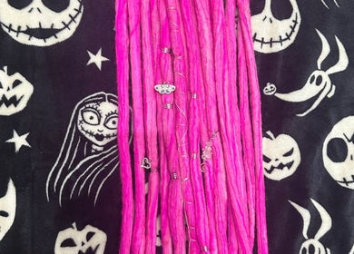 Vibrant pink locs from Whimsy Locs, Tuffley, England, GB, with Halloween-themed background.