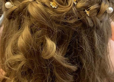 Elegant braided updo with pearls at Whimsy Locs, Tuffley, England, GB.