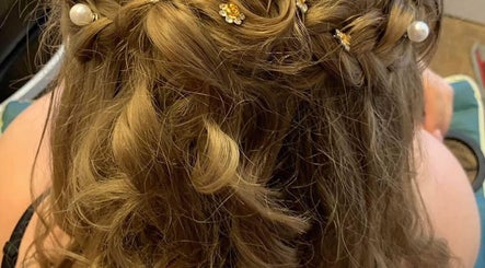 Elegant braided updo with pearls at Whimsy Locs, Tuffley, England, GB.