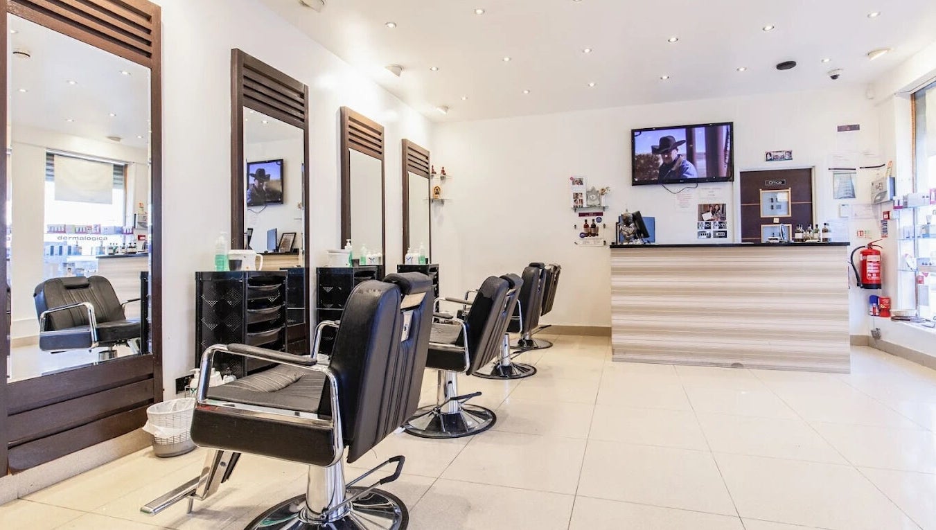 Modern salon interior at Ambiance Beauty, Hounslow, England, GB with stylish chairs and mirrors.