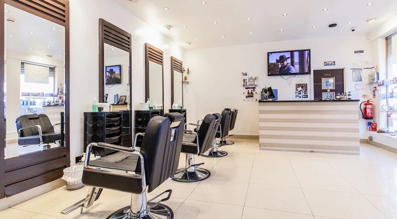 Modern salon interior at Ambiance Beauty, Hounslow, England, GB with stylish chairs and mirrors.