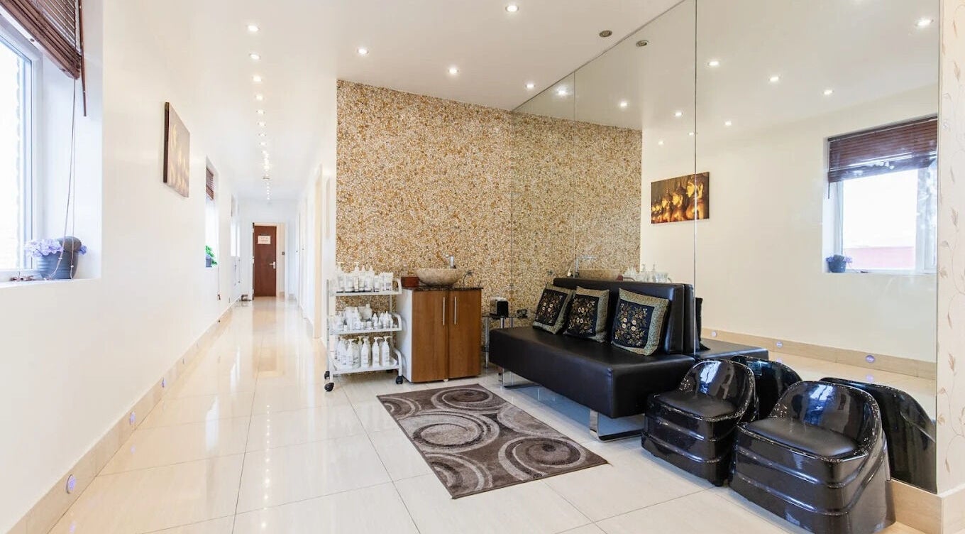 Elegant lounge area at Ambiance Beauty, Hounslow, England, GB, showcasing chic decor and plush seating.