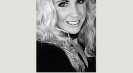 Professional image at SO hair in Stafford, England, GB, showcasing stylist with blonde curls and smiling expression.