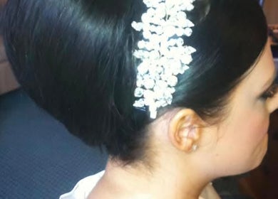 Elegant bridal hairstyle with a gem hairpiece at SO Hair in Stafford, England, GB.