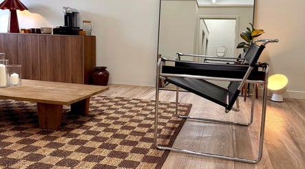 Modern lounge area at Strp. in Edinburgh, Scotland, GB with sleek chair and wooden accents.