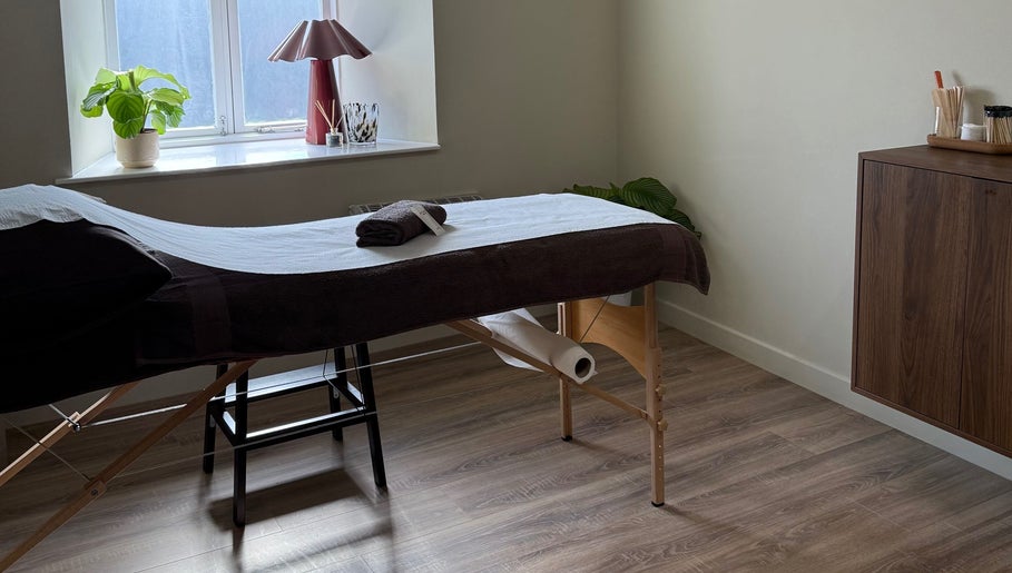 Serene massage room at strp. in Edinburgh, Scotland, GB with cozy table and calming decor.