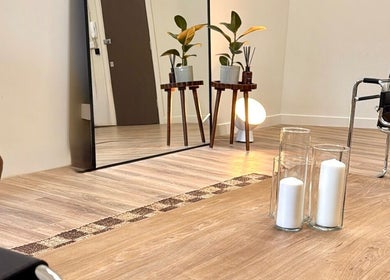 Chic interior of strp. venue in Edinburgh, Scotland, GB with modern decor, mirror, and calming candles.