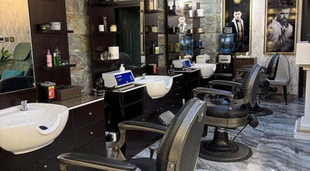 Elegant grooming stations at 700 Gents Salon - Voco, Dubai, Dubai, AE featuring modern barber chairs.