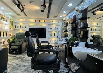Chic interior of 700 Gents Salon - Voco, Dubai, Dubai, AE with stylish chairs and washbasin station.