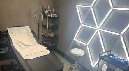 Modern treatment room at Sogoli Studio, Manchester, England, GB with illuminated wall and comfortable chair.