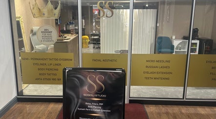 Entrance of Sogoli Studio in Manchester, England, GB showcasing beauty services signage.