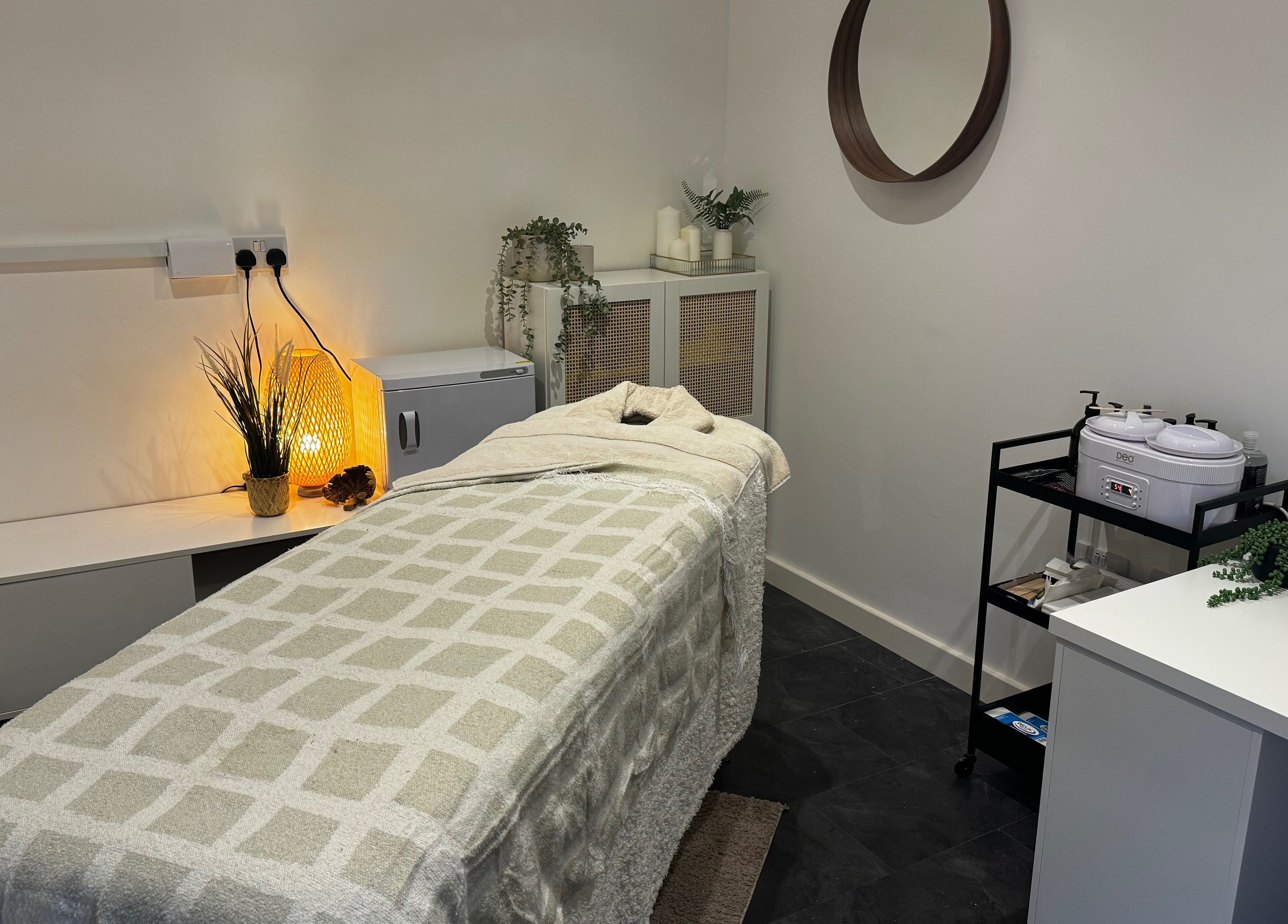 Cozy treatment room at Beauty By Mols, Somerton, England, GB, featuring a softly lit massage bed.