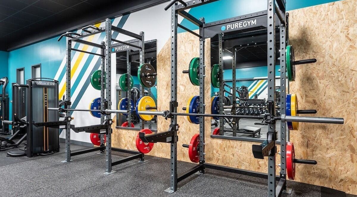 Vibrant gym setup at Fit With Pheebs, Weston-super-Mare, England, featuring colorful weight racks.