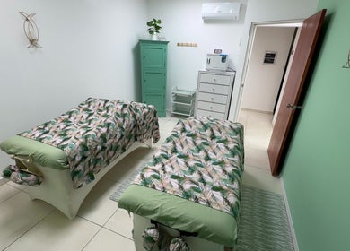 Peaceful massage room at Glorious Touch Day Spa, Oranjestad, AW with elegant decor and floral prints.