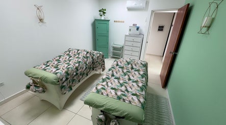 Peaceful massage room at Glorious Touch Day Spa, Oranjestad, AW with elegant decor and floral prints.