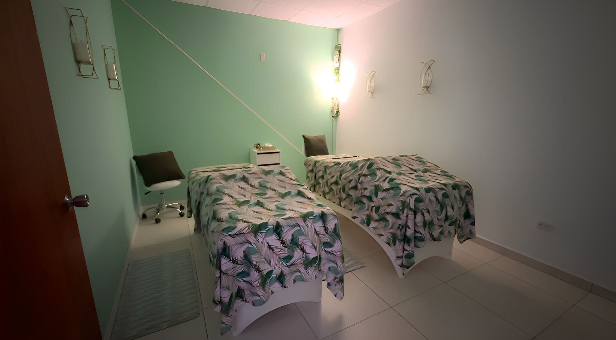 Peaceful massage room at Glorious Touch Day Spa, Oranjestad, AW with twin treatment beds.