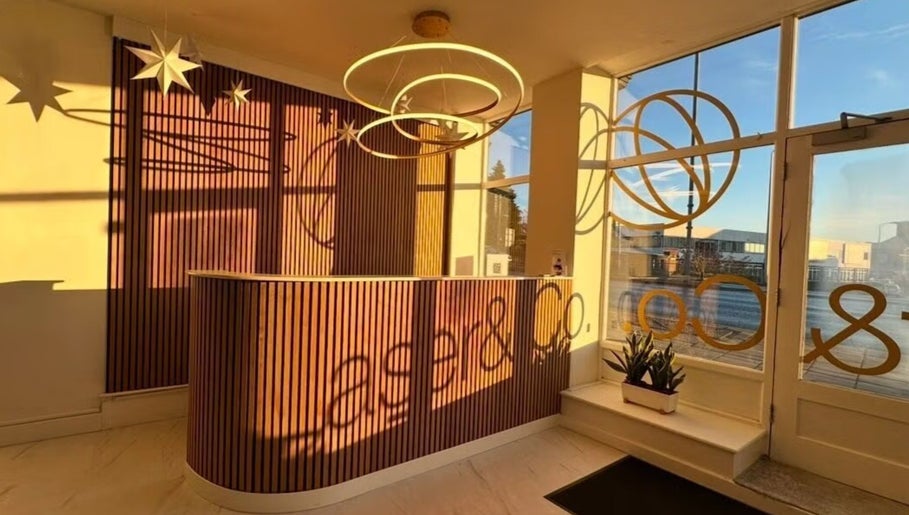 Elegant reception at The Nail Muse by Tasha, Carlisle, England, GB with circular lights and wood panels.