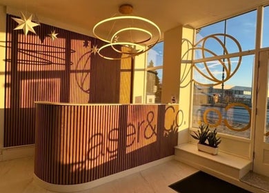 Elegant reception at The Nail Muse by Tasha, Carlisle, England, GB with circular lights and wood panels.