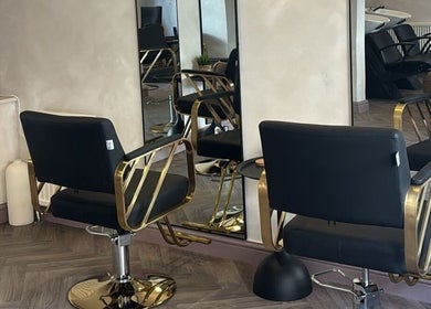 Modern salon chairs at Hair By B at Amica Hair & Beauty, Thirsk, England, GB featuring gold accents.