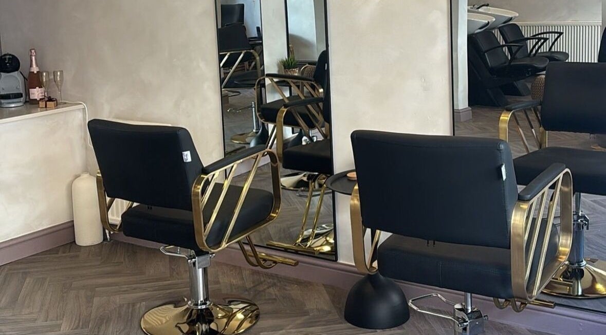 Modern salon chairs at Hair By B at Amica Hair & Beauty, Thirsk, England, GB featuring gold accents.