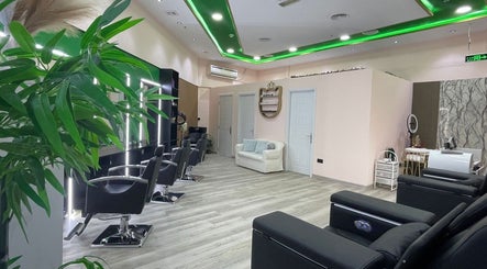 Sleek interior of Eraya Beauty Salon in Dubai, AE, featuring modern chairs and vibrant green decor.