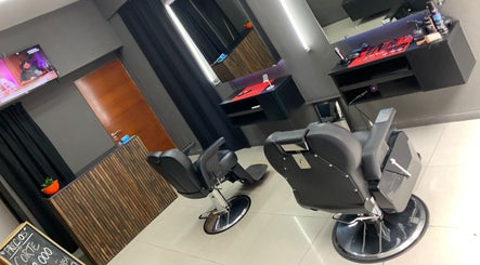 Interior moderno del Tata Barber Suite en Rosario, Santa Fe, AR, con sillas de peluquería y decoración elegante.