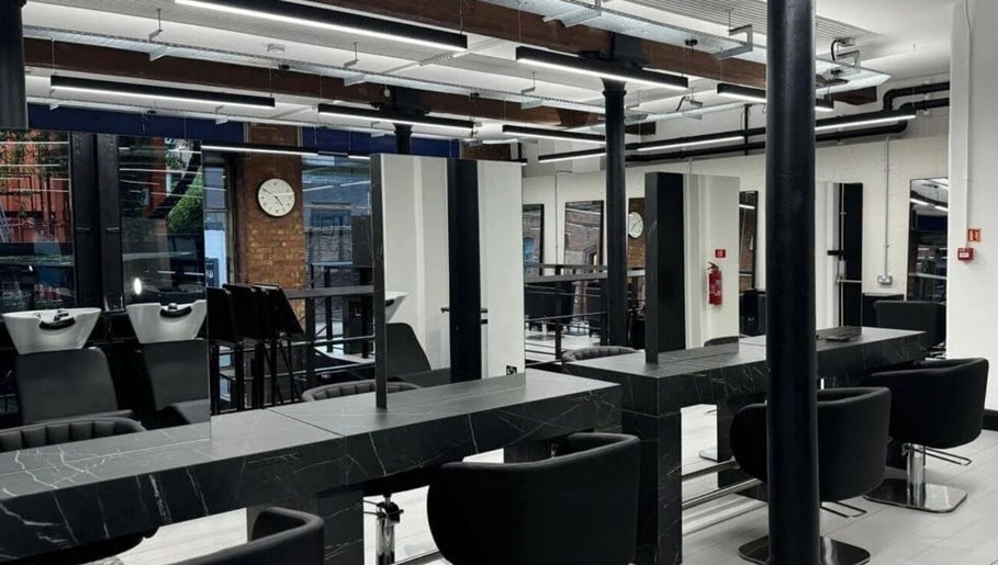 Modern salon interior at Hairbykatieanna, Manchester, England, GB, showcasing sleek design and professional setup.