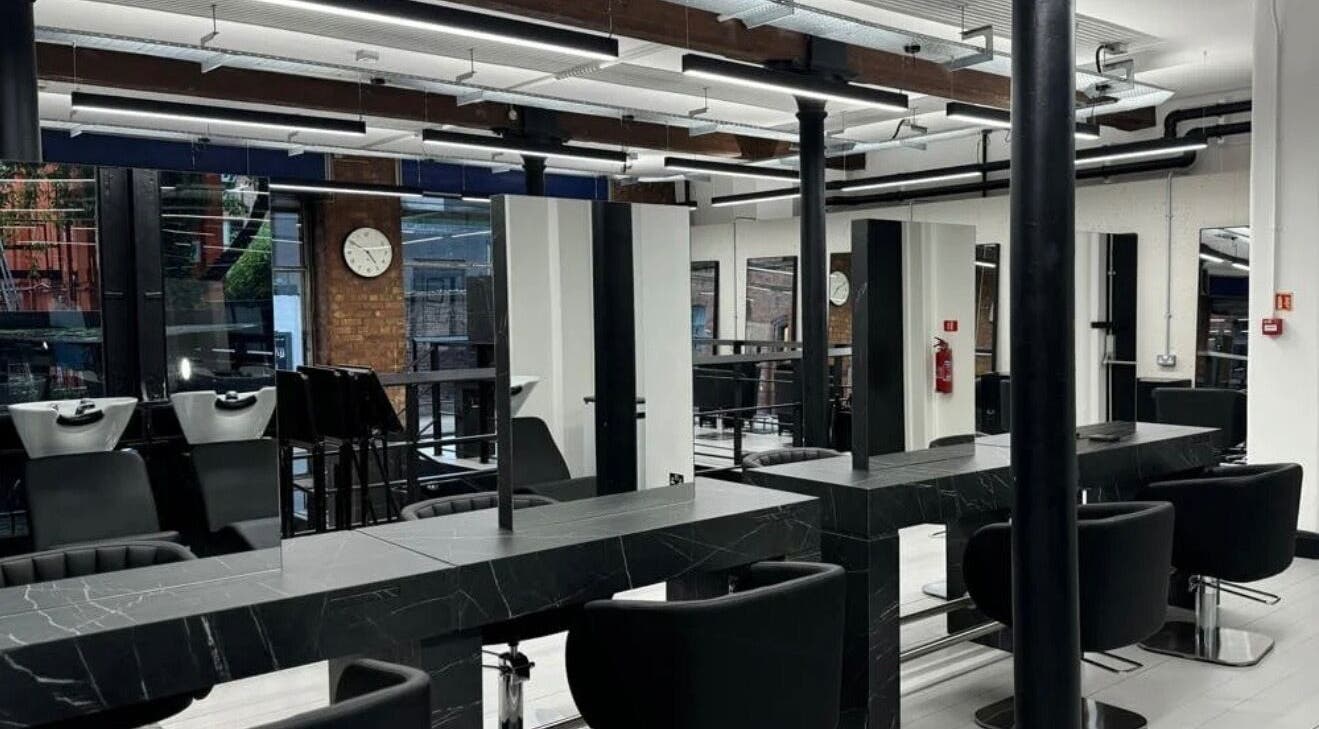 Modern salon interior at Hairbykatieanna, Manchester, England, GB, showcasing sleek design and professional setup.