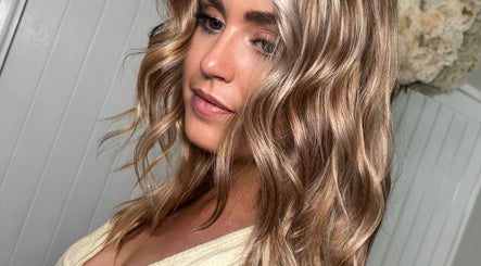 Woman with wavy blonde hair styled at Gemini Hair, Birmingham, England, GB.